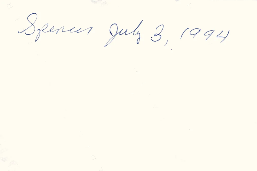 Back of a real 1994 print with a name and date in blue cursive
