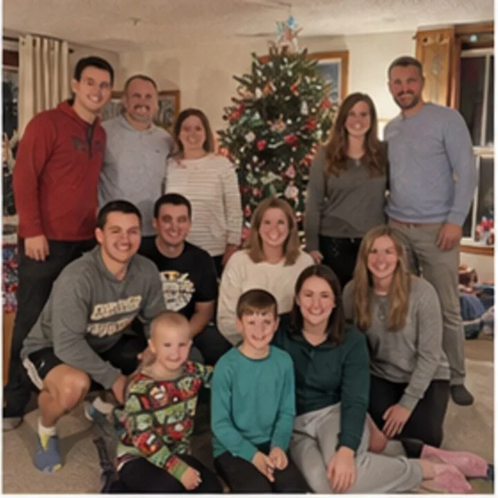 A large family posed in a living room in front of a decorated Christmas tree