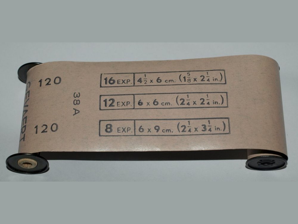 A roll of medium-format 120 film with its paper backing marked 120