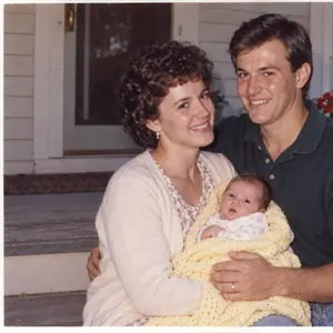 A 1994 print of a couple on a porch holding their baby