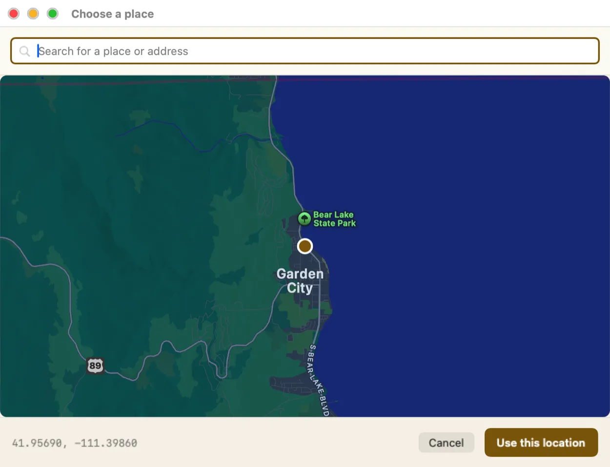 The big map picker open over the app, showing Bear Lake and Garden City with a pin dropped beside the shore, the coordinates in the bottom left and a Use this location button